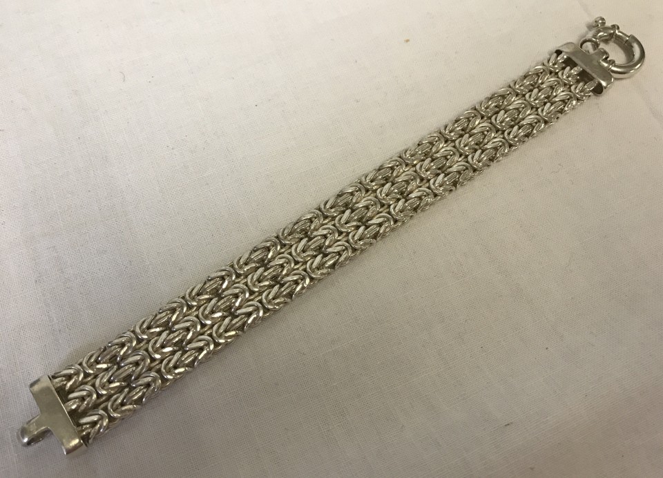 A triple rope design silver bracelet with large clasp fixing.