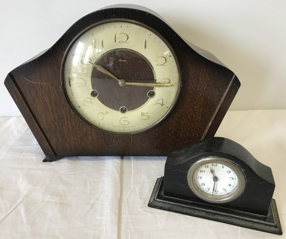 A vintage Smiths wooden cased mantle clock with key.
