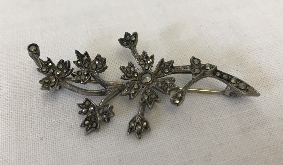 A 1950's hallmarked silver floral spray brooch set with marcasites.