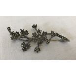 A 1950's hallmarked silver floral spray brooch set with marcasites.