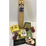 A box of assorted cricketing items.