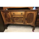 An early 20th century mahogany triple sideboard on cabriole legs.