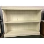 A cream painted 2 fixed shelf pine bookcase.