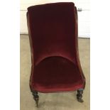 A Victorian ladies chair with red velvet upholstery.