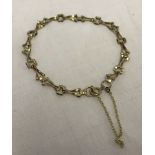 9ct gold bracelet with fancy links and safety chain.