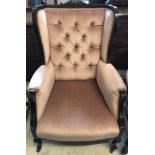 A late Victorian button backed wing chair with dusky pink velvet upholstery.