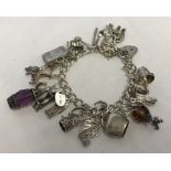 Silver charm bracelet with 20 charms.
