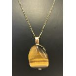 Large polished Tigers Eye stone set in a good quality hallmarked 9ct gold mount.