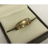 9ct gold hallmarked wedding band with engraved decoration.