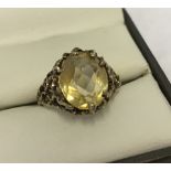 Vintage 9ct gold ring with an oval citrine stone set in a pierced mount and shoulders.