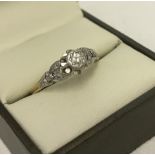 18ct gold diamond solitaire with ornate platinum setting.