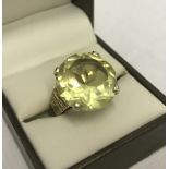 A hallmarked 9ct gold cocktail set with a very large round citrine stone.