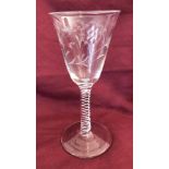 A Georgian wine glass with airtwist stem, heavily cut flower decoration to bowl. Conical foot.