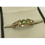 9ct gold 3 stone peridot ring with stepped shoulders.