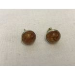 Hallmarked 9ct gold stud earrings set with amber cabochons.