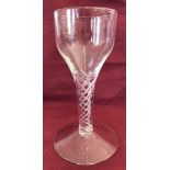 A Georgian wine glass with airtwist stem and large conical foot.