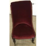 A Victorian ladies chair with red velvet upholstery.