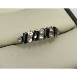 9ct gold half eternity ring set with clear and dark blue stones.