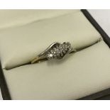 18ct gold 3 stone diamond ring with cross over shank.