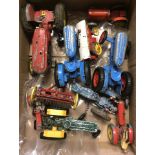 A box of play worn diecast tractors.