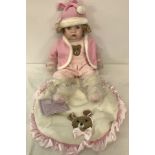 A boxed Leonardo collection collectors baby doll with teddy bear blanket.