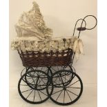 A reproduction vintage style basket body and lace hood dolls pram.