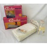 A boxed Sindy bed together with a boxed bedside table, light up lamp and breakfast tray.