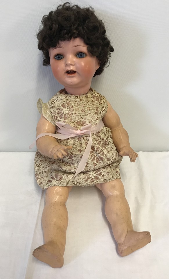 A vintage composite fully jointed doll with teeth and close eye action.