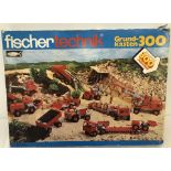 A vintage boxed Fischertechnik construction set complete with instruction booklet and parts list.