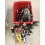 A box a Transformer and Godzilla action figures.