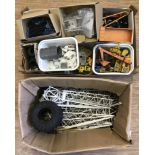 A box of assorted diecast vehicle parts for spares or repair.