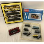 A box of N gauge railway locos, trucks and Lineside kit.