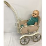 A vintage Marmet metal framed dolls pushchair together with a vintage doll.