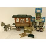 An unboxed Sylvanian Families Caravan together with 3 boxed figures.
