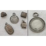 A small collection of silver and white metal pendants and charms.