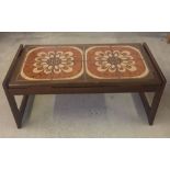 A c1970s brown tiled topped coffee table.