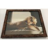 A signed photograph of Madonna, framed and glazed.
