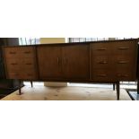 A large retro 1970's sideboard with 6 drawers and central double door cupboard.