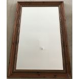 A modern wood framed wall hanging mirror.