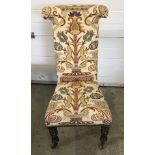 A Victorian hall chair with turned front legs and T shaped high back.