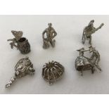 A collection of 6 vintage white metal bracelet charms.