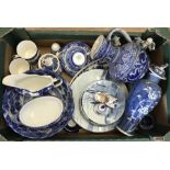 A box of assorted blue and white ceramics.