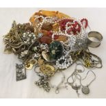 A small quantity of costume jewellery to include gold tone necklaces and shell bead necklace.