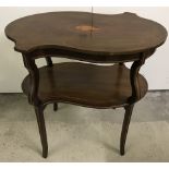 A decorative Victorian occasional table with shaped top and under shelf.