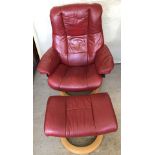 A Red Paloma leather and light wood modern lounge chair with matching footstool.