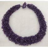 An amethyst collar style necklace made from chips with unusual amethyst stone clasp.