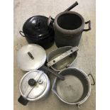A collection of vintage cooking pots and pans.