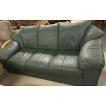 A modern green leather 3 seater settee with fixed cushions.