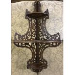 A vintage 3 tier corner shelf with ornate fretwork sides.