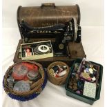 Cased singer sewing machine with vintage sewing accessories.
